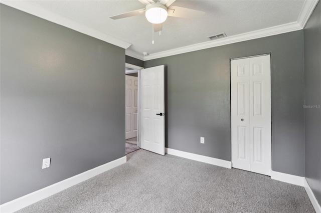330 Ponce Deleon Blvd, De Leon Springs, FL 32130 - unfurnished bedroom featuring crown molding, carpet flooring, a closet, and a ceiling fan
