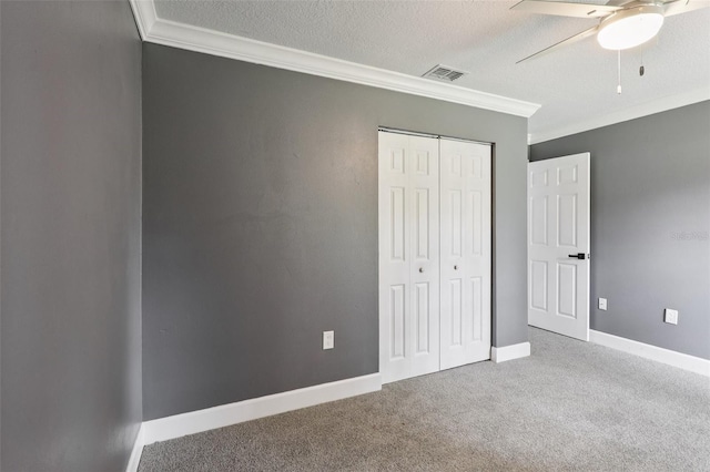 330 Ponce Deleon Blvd, De Leon Springs, FL 32130 - unfurnished bedroom featuring ornamental molding, a textured ceiling, carpet floors, a closet, and a ceiling fan