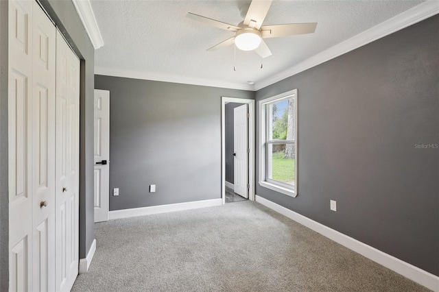 330 Ponce Deleon Blvd, De Leon Springs, FL 32130 - unfurnished bedroom with crown molding, a closet, a textured ceiling, carpet, and a ceiling fan