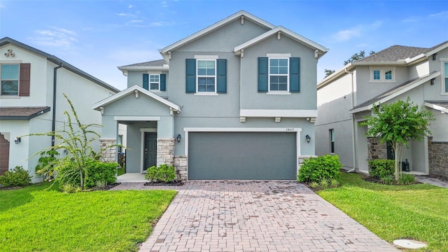 2807 Priego Blvd, Kissimmee, FL 34744 - view of front of house with stucco siding, decorative driveway, and a front yard
