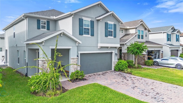 2807 Priego Blvd, Kissimmee, FL 34744 - view of front of house with stucco siding, an attached garage, stone siding, decorative driveway, and a front lawn