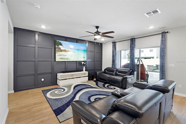 2807 Priego Blvd, Kissimmee, FL 34744 - home theater featuring light wood-type flooring, a ceiling fan, a decorative wall, and recessed lighting