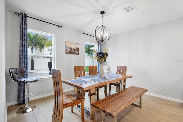2807 Priego Blvd, Kissimmee, FL 34744 - dining area featuring a chandelier, light wood finished floors, and healthy amount of natural light