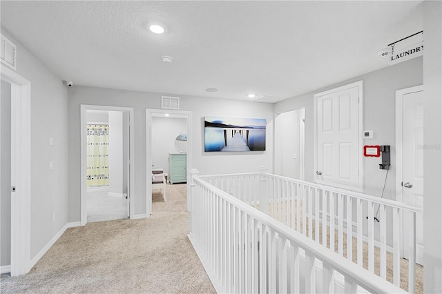 2807 Priego Blvd, Kissimmee, FL 34744 - corridor with carpet, a textured ceiling, and recessed lighting