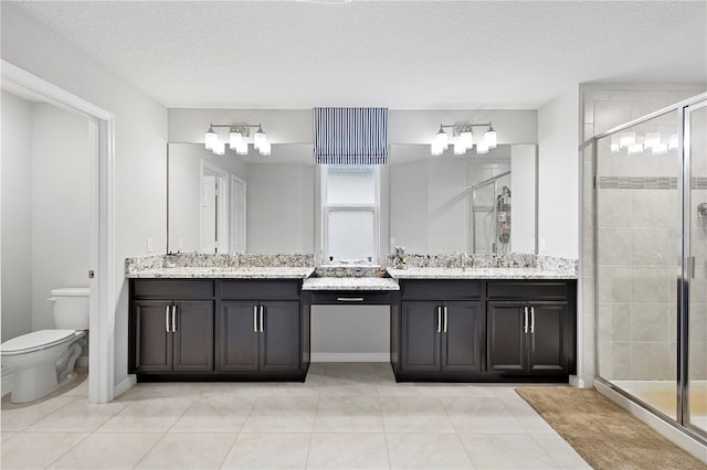 2807 Priego Blvd, Kissimmee, FL 34744 - full bath with vanity, a shower stall, tile patterned flooring, and a textured ceiling