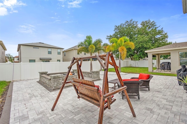 2807 Priego Blvd, Kissimmee, FL 34744 - fenced backyard featuring a patio and an outdoor living space with a fire pit