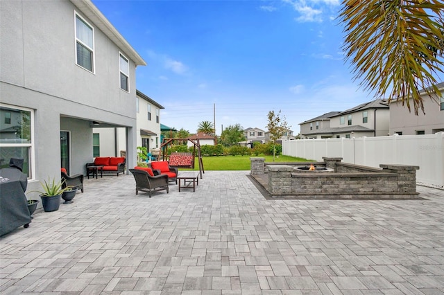 2807 Priego Blvd, Kissimmee, FL 34744 - fenced backyard with an outdoor living space with a fire pit, a patio, and a residential view