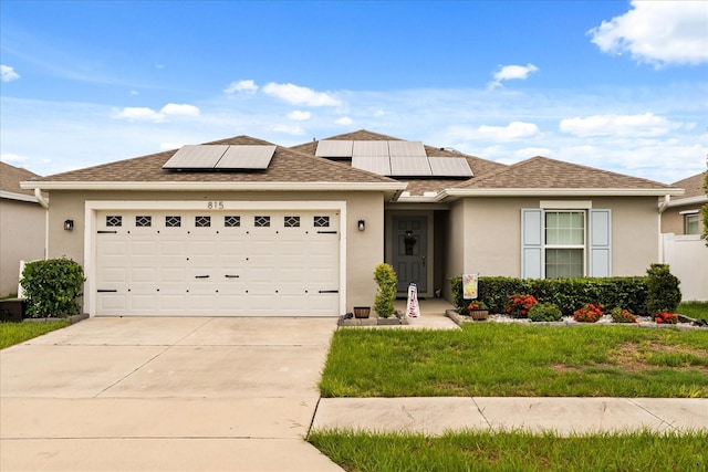 815 Fillmore Ct, Davenport, FL 33837 - view of front of home featuring an attached garage, driveway, stucco siding, and solar panels