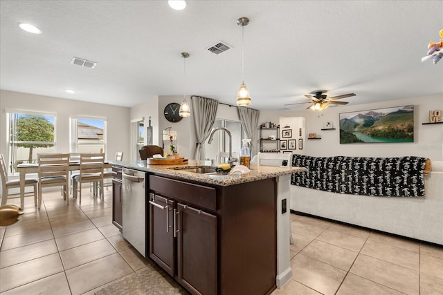 815 Fillmore Ct, Davenport, FL 33837 - kitchen featuring stainless steel dishwasher, dark brown cabinetry, light stone countertops, pendant lighting, and a ceiling fan