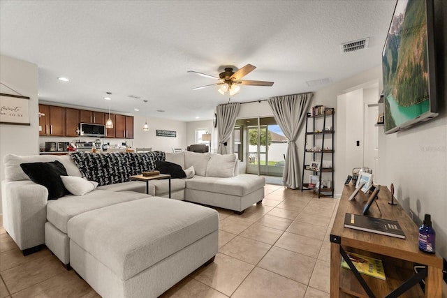 815 Fillmore Ct, Davenport, FL 33837 - living room with a ceiling fan, light tile patterned floors, recessed lighting, and a textured ceiling