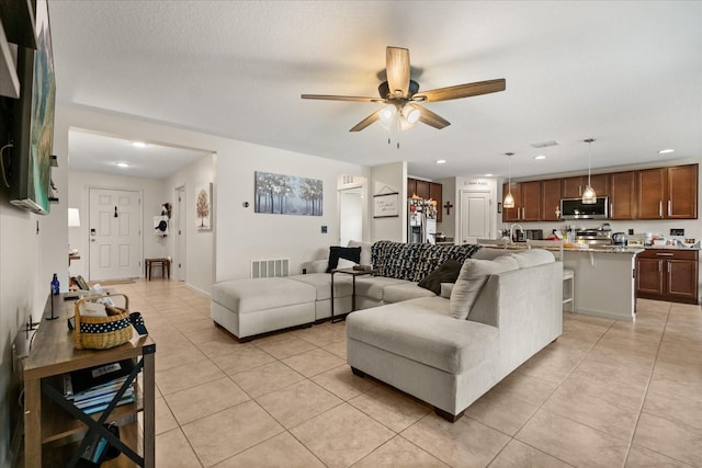 815 Fillmore Ct, Davenport, FL 33837 - living area with light tile patterned floors, ceiling fan, and recessed lighting