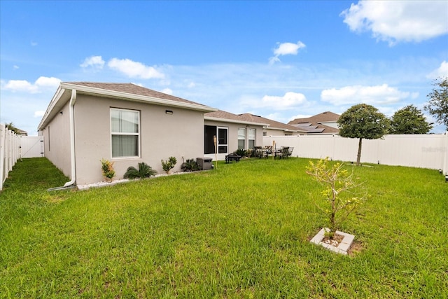 815 Fillmore Ct, Davenport, FL 33837 - back of property with a fenced backyard and stucco siding