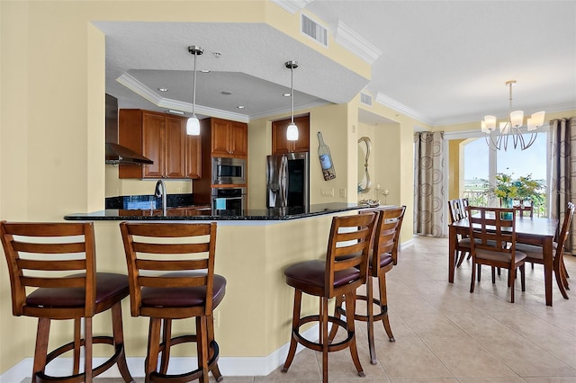 3343 S Atlantic Ave Unit 601, Daytona Beach Shores, FL 32118 - kitchen featuring wall chimney exhaust hood, stainless steel appliances, a chandelier, a peninsula, and brown cabinets