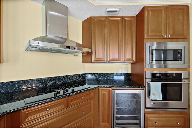 3343 S Atlantic Ave Unit 601, Daytona Beach Shores, FL 32118 - kitchen with wine cooler, wall chimney exhaust hood, stainless steel appliances, and brown cabinetry