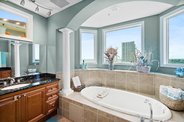 3343 S Atlantic Ave Unit 601, Daytona Beach Shores, FL 32118 - full bath featuring decorative columns, a garden tub, vanity, and plenty of natural light