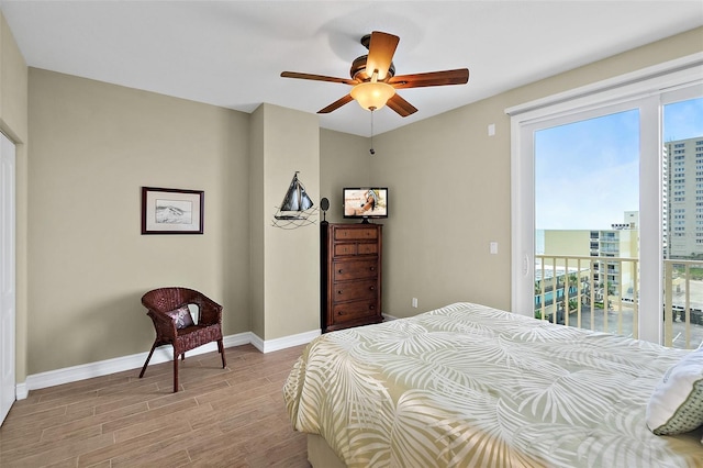 3343 S Atlantic Ave Unit 601, Daytona Beach Shores, FL 32118 - bedroom featuring light wood-style floors, multiple windows, access to exterior, and ceiling fan