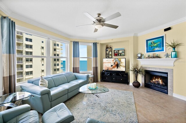 3343 S Atlantic Ave Unit 601, Daytona Beach Shores, FL 32118 - living room featuring ornamental molding, tile patterned flooring, ceiling fan, and a tiled fireplace
