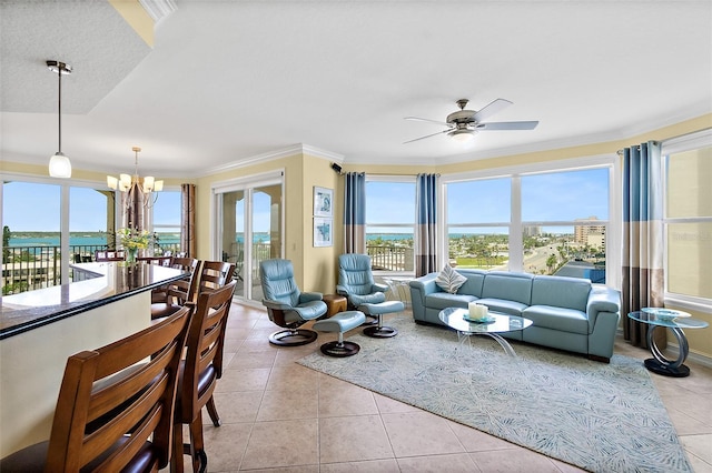 3343 S Atlantic Ave Unit 601, Daytona Beach Shores, FL 32118 - living room featuring a chandelier, a ceiling fan, light tile patterned floors, healthy amount of natural light, and ornamental molding
