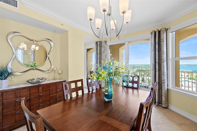 3343 S Atlantic Ave Unit 601, Daytona Beach Shores, FL 32118 - dining room featuring a chandelier, crown molding, and light tile patterned floors