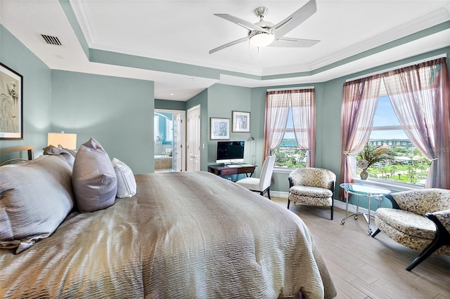 3343 S Atlantic Ave Unit 601, Daytona Beach Shores, FL 32118 - bedroom with a tray ceiling, crown molding, wood finished floors, connected bathroom, and a ceiling fan