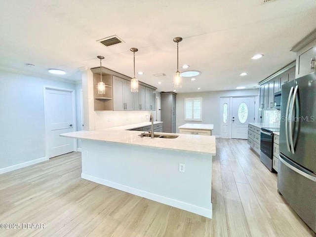 2017 Old Daytona Rd, Port Orange, FL 32128 - kitchen with stainless steel appliances, a peninsula, light wood-style flooring, open shelves, and gray cabinetry