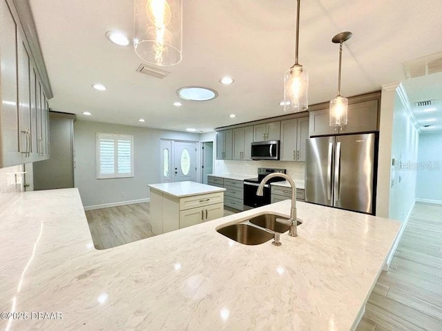 2017 Old Daytona Rd, Port Orange, FL 32128 - kitchen featuring appliances with stainless steel finishes, a kitchen island, light stone counters, and recessed lighting