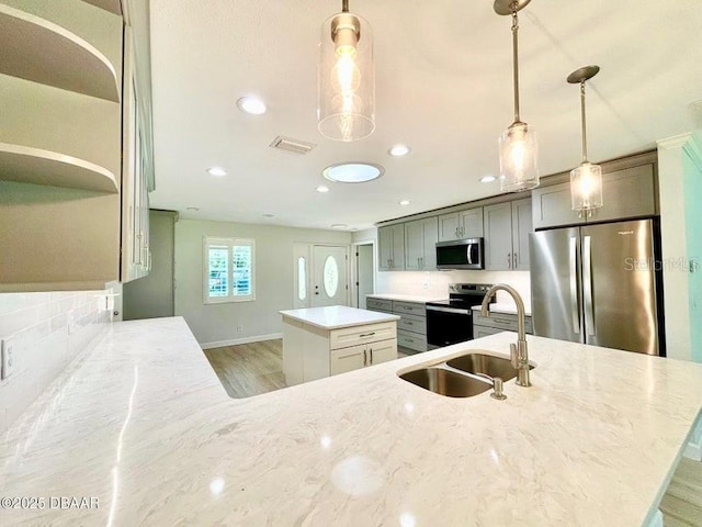 2017 Old Daytona Rd, Port Orange, FL 32128 - kitchen featuring stainless steel appliances, a kitchen island, recessed lighting, light wood-style floors, and light stone countertops