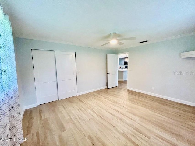 2017 Old Daytona Rd, Port Orange, FL 32128 - unfurnished bedroom featuring light wood finished floors, a closet, crown molding, and ceiling fan