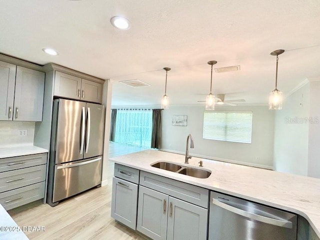 2017 Old Daytona Rd, Port Orange, FL 32128 - kitchen featuring stainless steel appliances, gray cabinets, ornamental molding, decorative light fixtures, and recessed lighting
