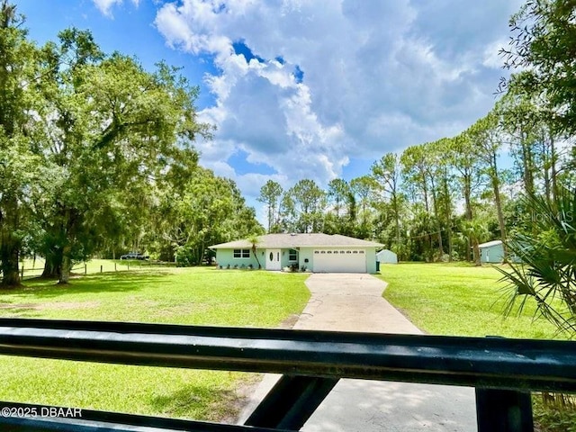 2017 Old Daytona Rd, Port Orange, FL 32128 - view of front of house featuring a front yard, an attached garage, and driveway