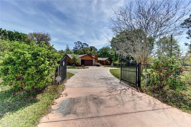 2345 Tomoka Farms Rd, Port Orange, FL 32128 - view of front of property with a garage, driveway, and a gate