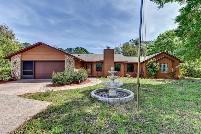 2345 Tomoka Farms Rd, Port Orange, FL 32128 - single story home featuring a chimney, a garage, a front lawn, decorative driveway, and a shingled roof