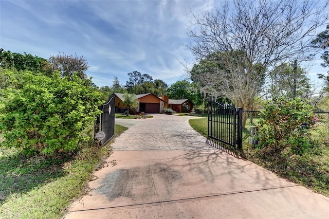 2345 Tomoka Farms Rd, Port Orange, FL 32128 - view of front facade with a garage, a gate, and driveway