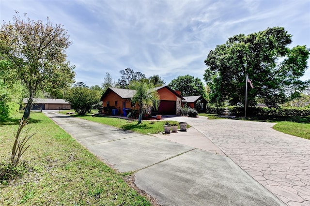 2345 Tomoka Farms Rd, Port Orange, FL 32128 - single story home with concrete driveway, a front yard, and a garage