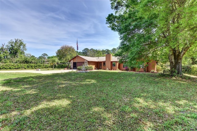 2345 Tomoka Farms Rd, Port Orange, FL 32128 - single story home featuring an attached garage, concrete driveway, a front yard, and a chimney