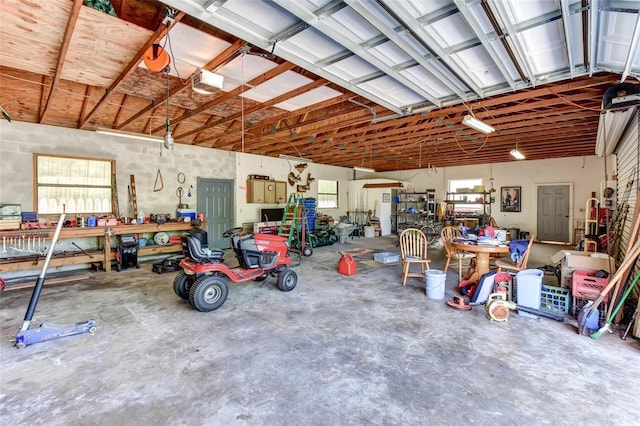 2345 Tomoka Farms Rd, Port Orange, FL 32128 - garage with a workshop area and a garage door opener