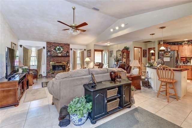 2345 Tomoka Farms Rd, Port Orange, FL 32128 - living room featuring a ceiling fan, vaulted ceiling, light tile patterned floors, and a fireplace