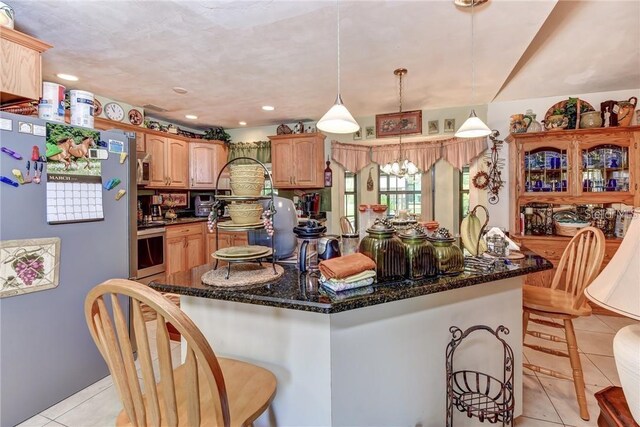 2345 Tomoka Farms Rd, Port Orange, FL 32128 - kitchen with appliances with stainless steel finishes, light tile patterned flooring, a kitchen island, dark stone countertops, and recessed lighting