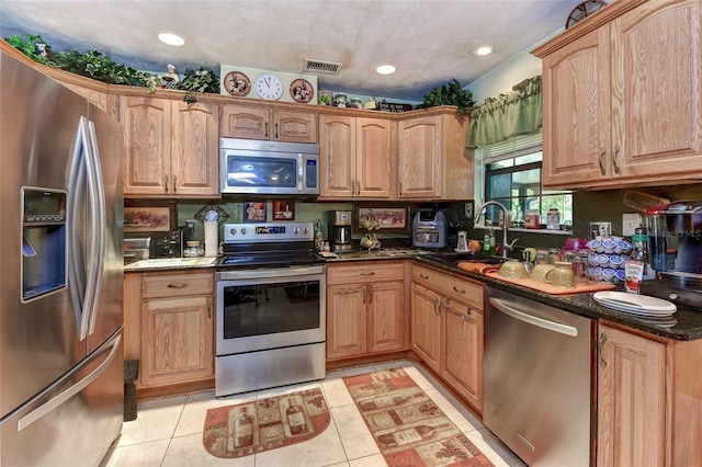 2345 Tomoka Farms Rd, Port Orange, FL 32128 - kitchen with appliances with stainless steel finishes, light tile patterned floors, recessed lighting, and dark stone countertops