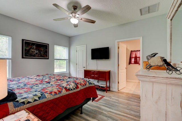 5005 Joseph St, Hastings, FL 32145 - bedroom with light wood-style flooring, a ceiling fan, and ensuite bath