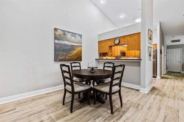 1636 Areca Palm Dr, Port Orange, FL 32128 - dining space featuring light wood-style floors, high vaulted ceiling, and recessed lighting