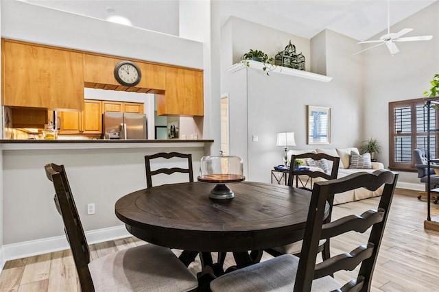 1636 Areca Palm Dr, Port Orange, FL 32128 - dining room featuring high vaulted ceiling, ceiling fan, and light wood-type flooring