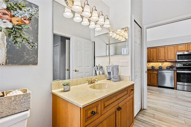 1636 Areca Palm Dr, Port Orange, FL 32128 - bathroom featuring vanity, wood finished floors, and decorative backsplash