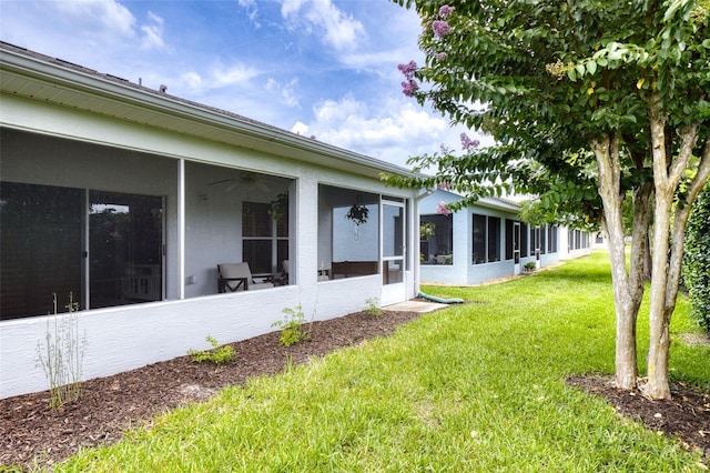 1636 Areca Palm Dr, Port Orange, FL 32128 - view of green lawn featuring a sunroom and a ceiling fan