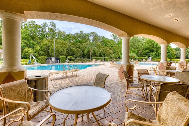 1636 Areca Palm Dr, Port Orange, FL 32128 - view of patio / terrace with a community pool and view of wooded area