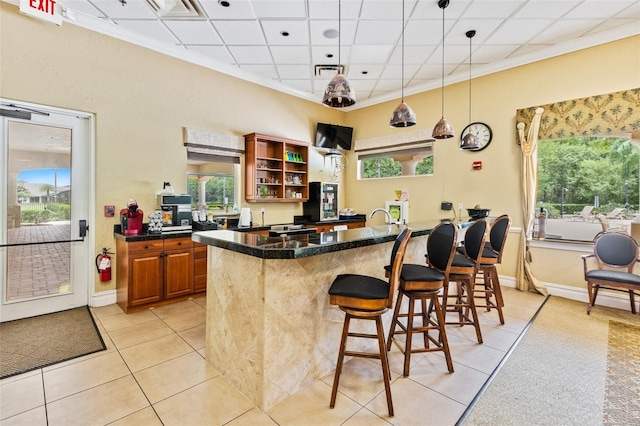 1636 Areca Palm Dr, Port Orange, FL 32128 - bar area with light tile patterned floors, ornamental molding, and pendant lighting