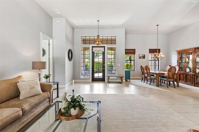 6710 Merryvale Ln, Port Orange, FL 32128 - living room with light tile patterned flooring and a chandelier