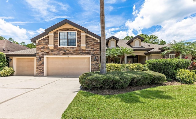 6710 Merryvale Ln, Port Orange, FL 32128 - view of front of home featuring concrete driveway, stone siding, a front yard, and an attached garage