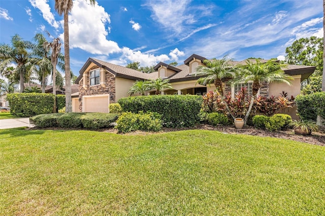 6710 Merryvale Ln, Port Orange, FL 32128 - view of front of home featuring stone siding, an attached garage, stucco siding, and a front yard