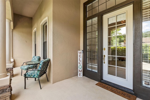 6710 Merryvale Ln, Port Orange, FL 32128 - doorway to property with stucco siding and a porch